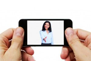 Person holding a phone screen with a woman 