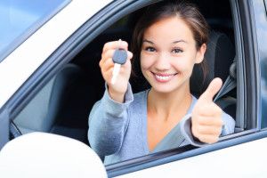 Happy woman with car keys